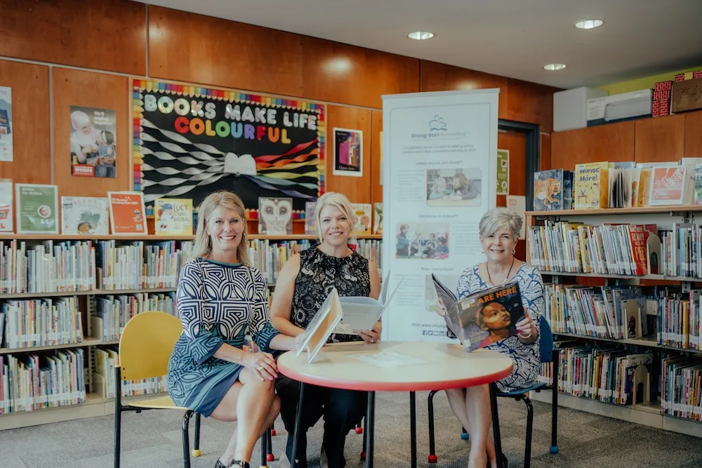 A group of people sitting in a library