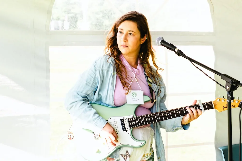 A woman plays an electric guitar