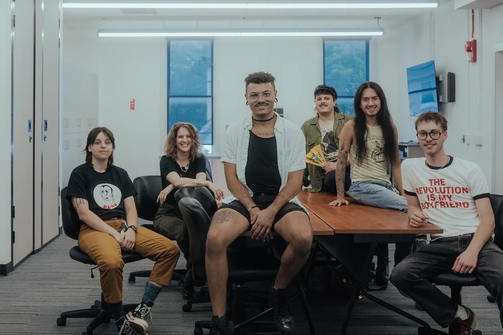 A group of young people sitting around a large table
