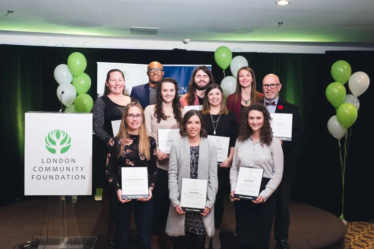 A group of people holding their awards