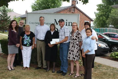 several people standing in front of a sign