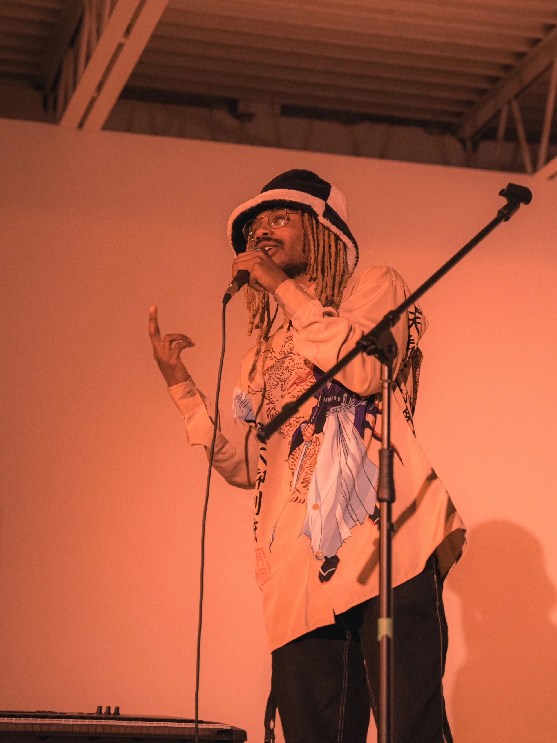 person singing into microphone on stage