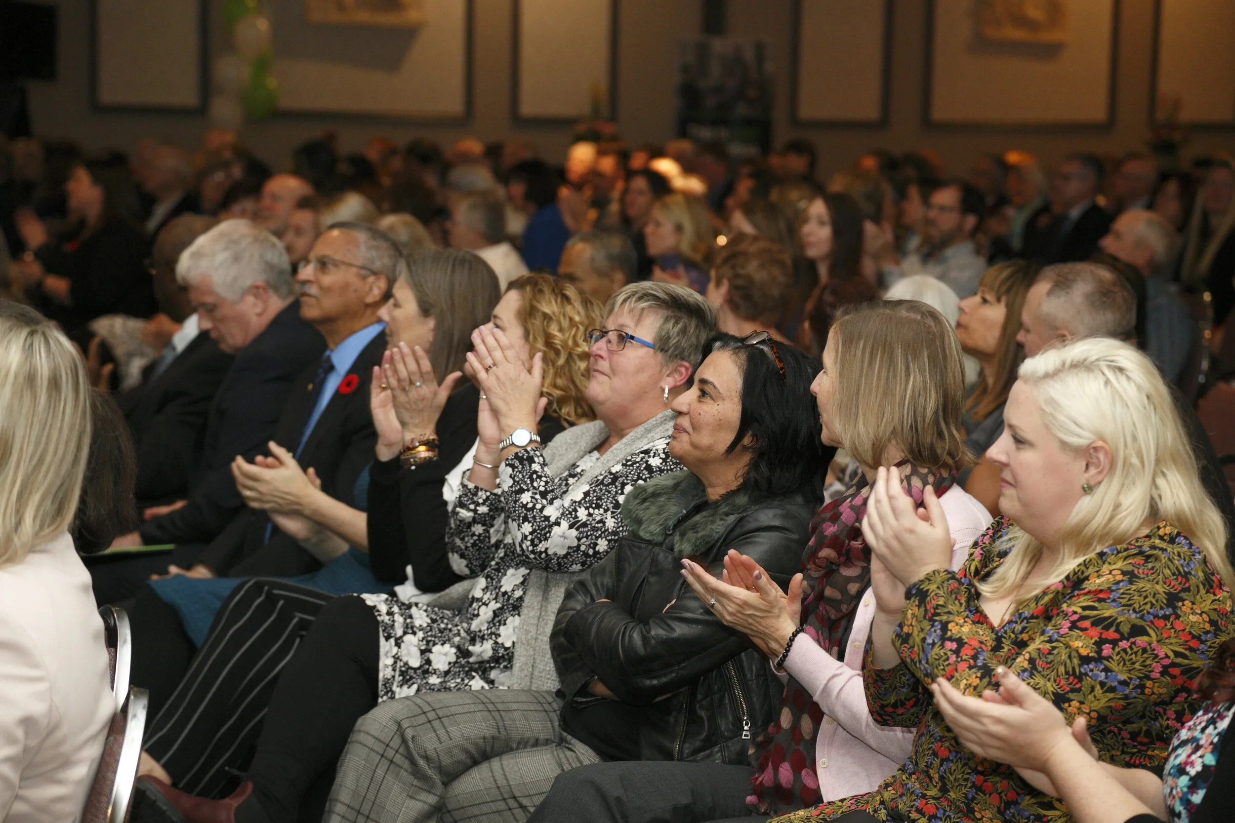 seated audience clapping