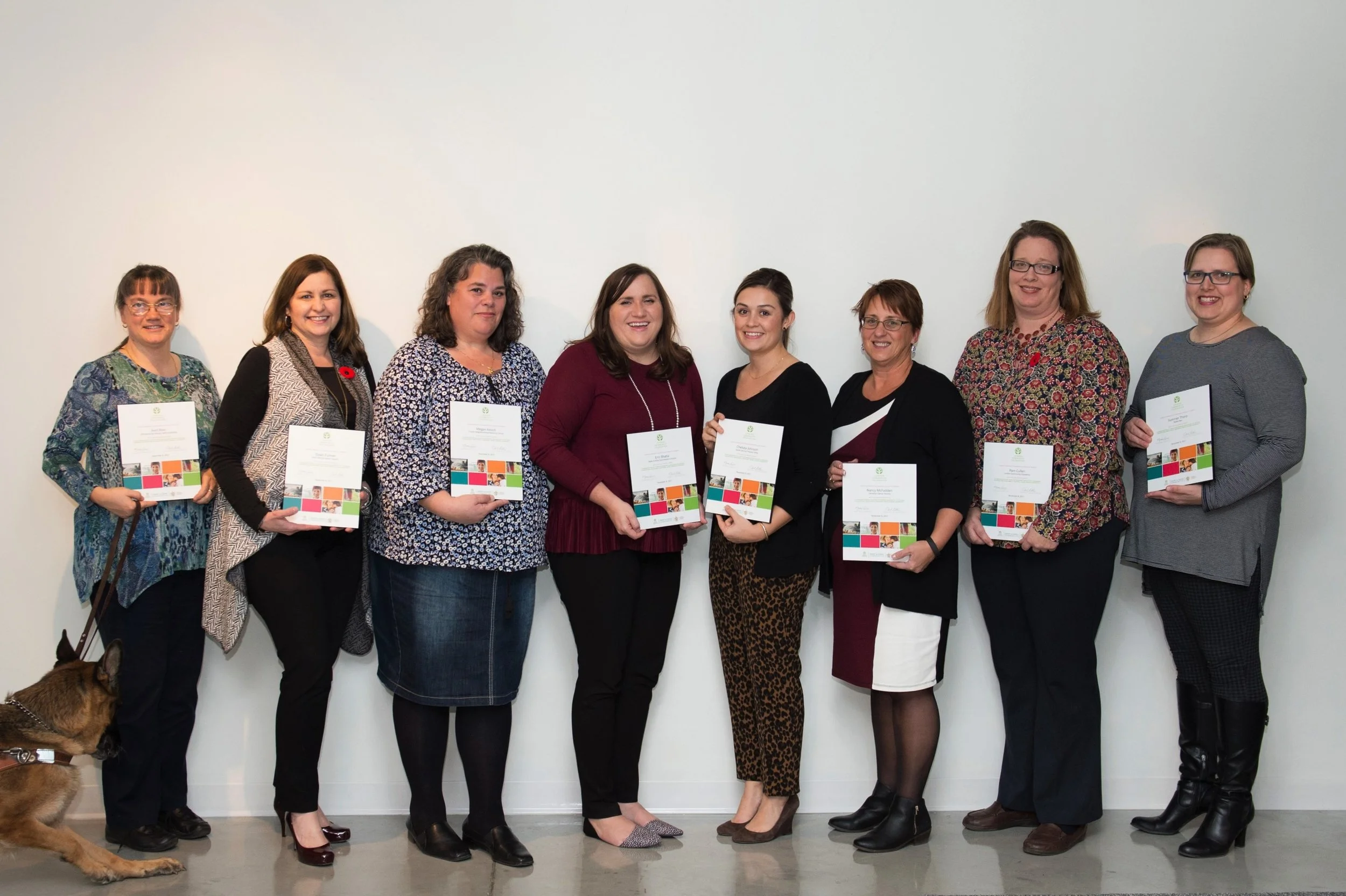 Group of people holding award certificates